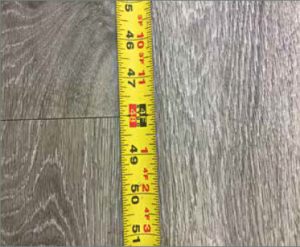 In this example, the vinyl plank measured exactly 48 in. as it was supposed to. However, acclimation and adhesive open time were not followed and that caused the tile to gap.
